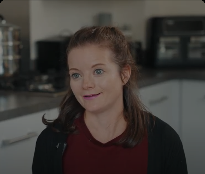 Emily, a Southern Softflow customer, sharing her testimonial in her kitchen