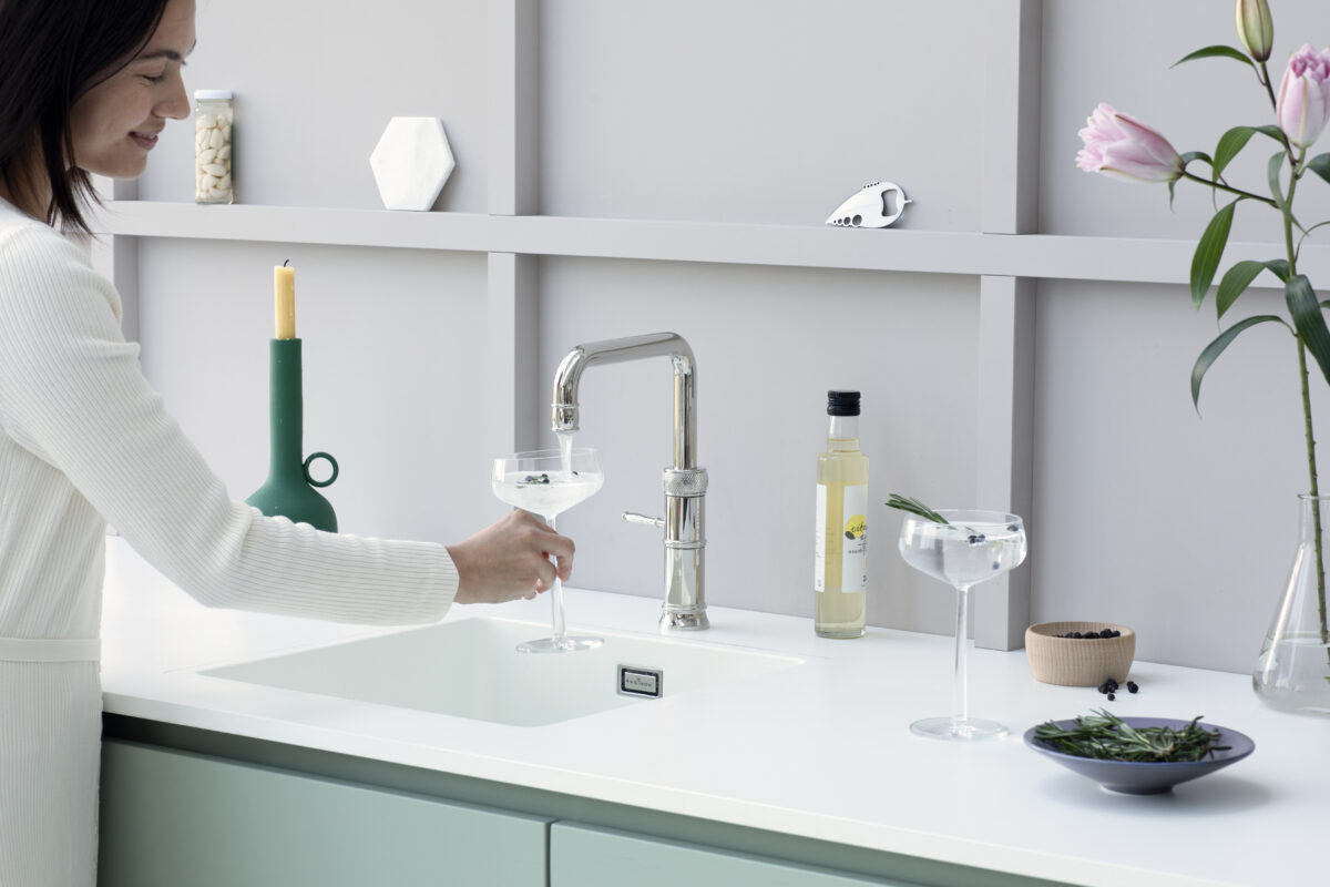 Quooker Cube chilled and sparkling water dispenser in a modern sage green kitchen