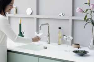 Quooker Cube chilled and sparkling water dispenser in a modern sage green kitchen