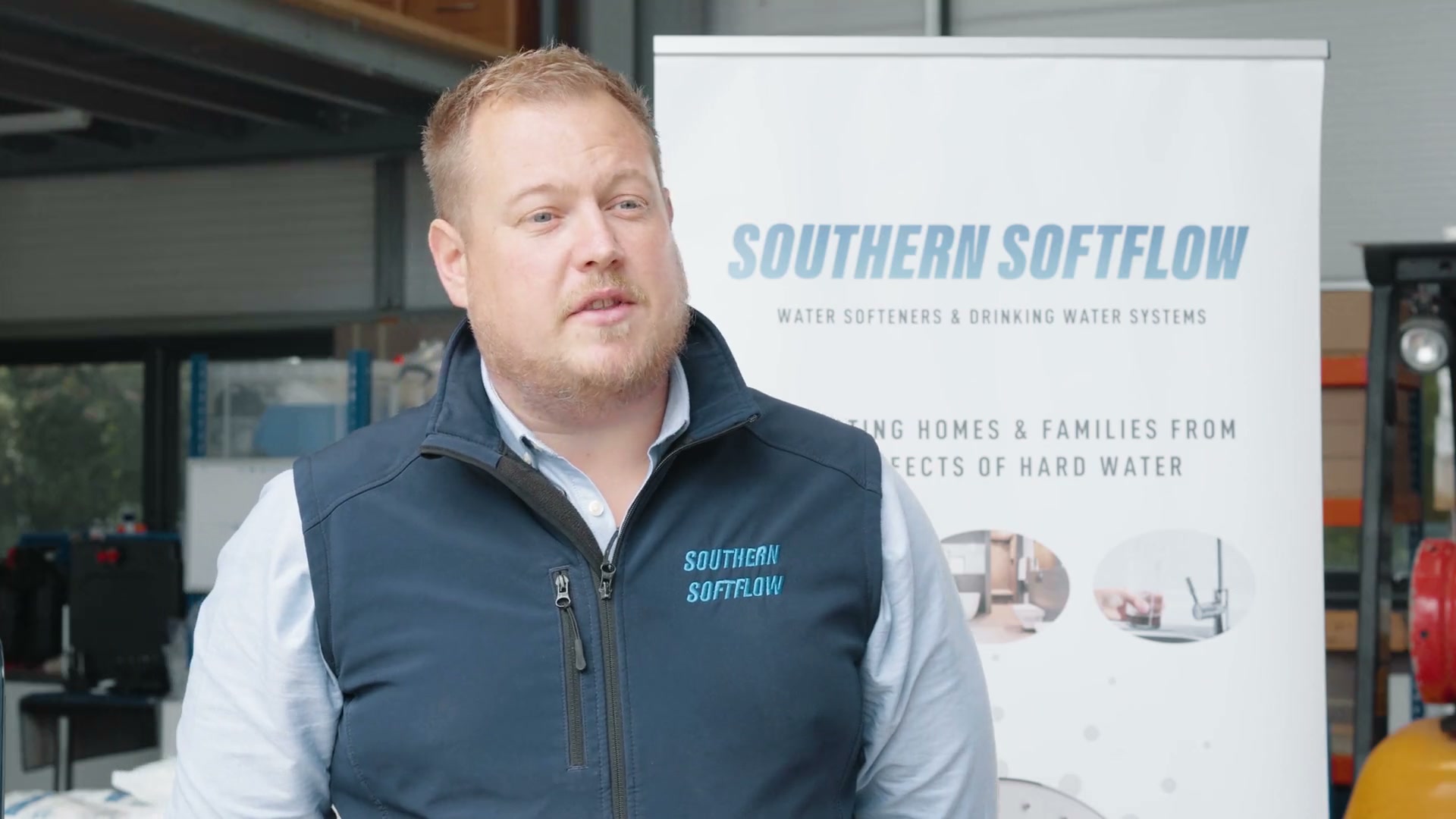 Ben Southern presenting hard water problems at the Southern Softflow warehouse with branded banner