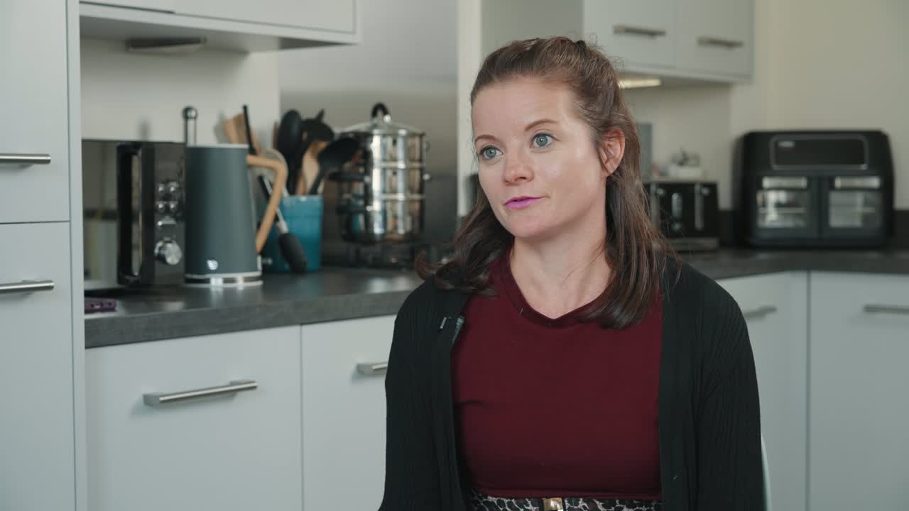 Female customer Emily giving a video testimonial about Southern Softflow in her kitchen